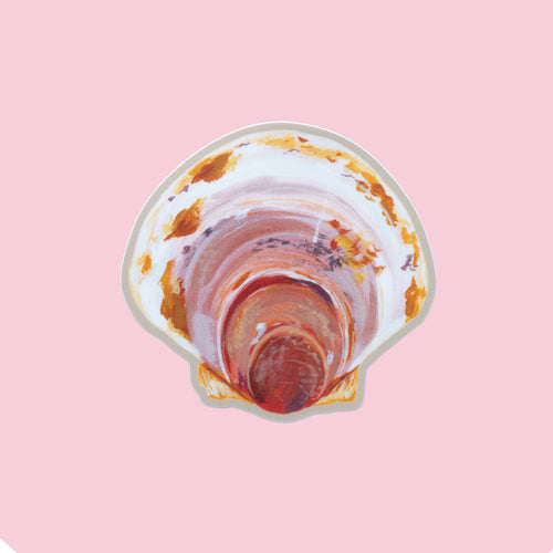 A die-cut sticker depicting an Atlantic scallop shell, shown on a solid light pink background.